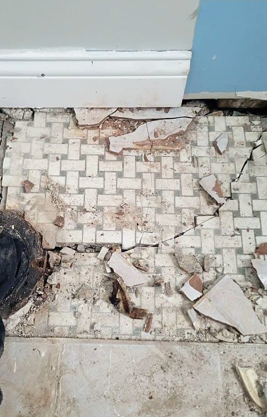 Before: Cracked and broken original mosaic tile floor