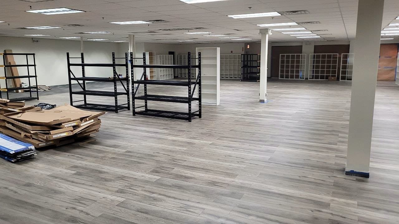 After: The space finished with gray wood-look plank flooring throughout