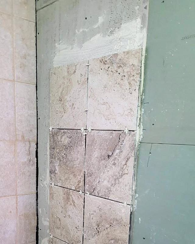 Before: Tub wall with cement board and the first rows of tile set